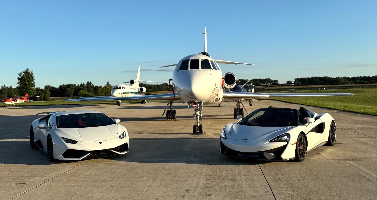 Exotic supercars with a private jet on the tarmac